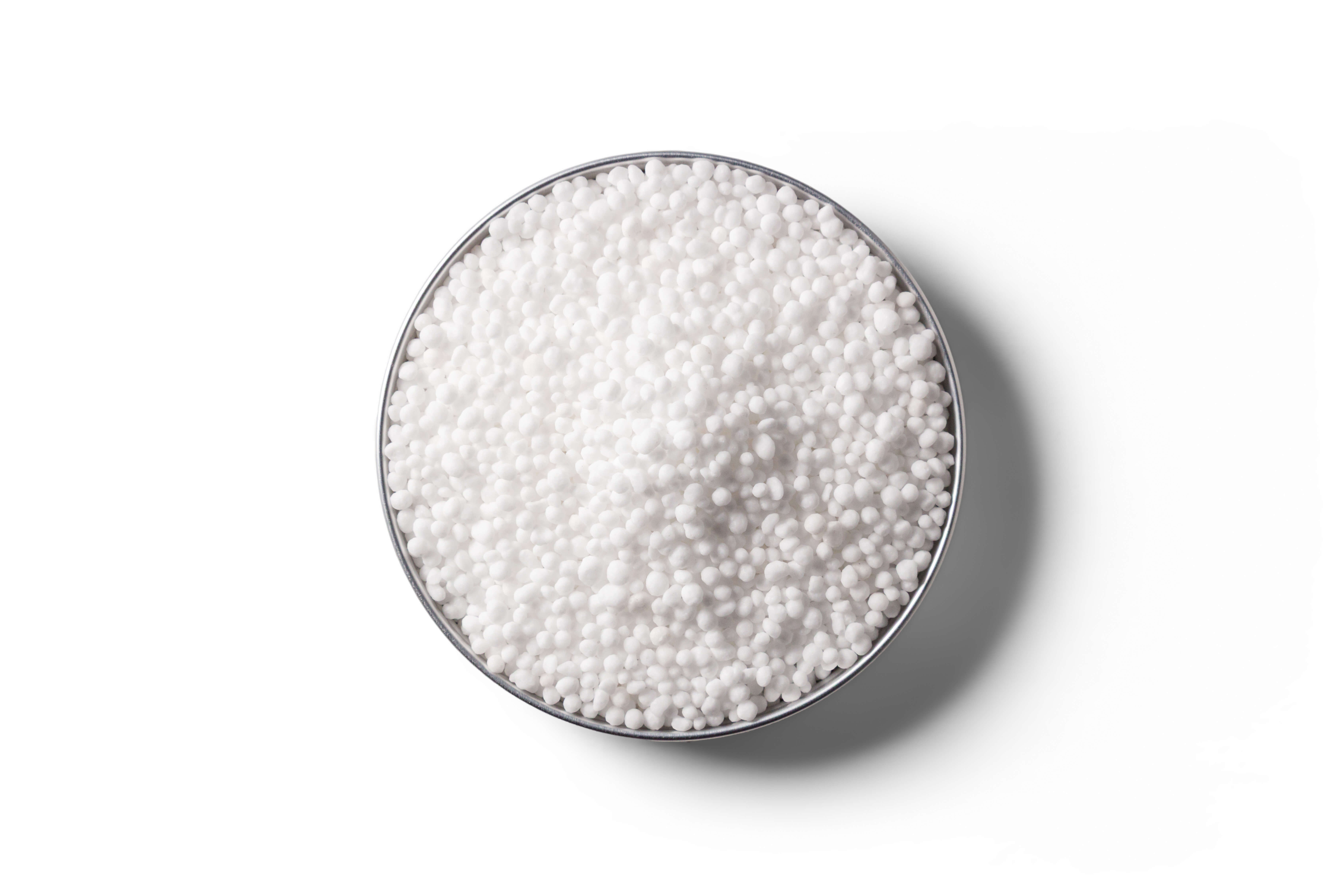 White urea fertiliser granules in a round dish